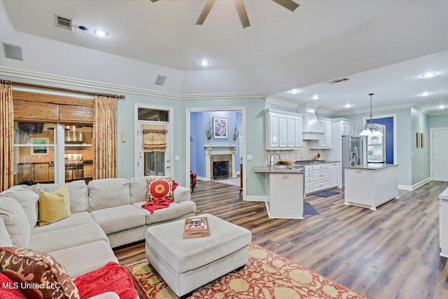 611 Berridge Dr, Ridgeland, MS 39157 - living room with ceiling fan, dark wood-style flooring, baseboards, crown molding, and a high end fireplace