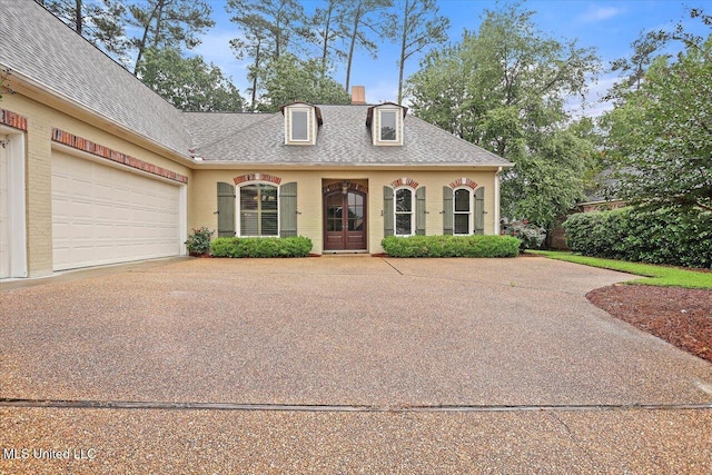 611 Berridge Dr, Ridgeland, MS 39157 - view of front of property with an attached garage, roof with shingles, a chimney, and concrete driveway