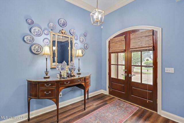 611 Berridge Dr, Ridgeland, MS 39157 - entrance foyer with french doors, dark wood finished floors, baseboards, arched walkways, and a chandelier