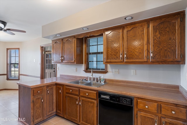 kitchen with a sink, black dishwasher, a peninsula, brown cabinetry, and ceiling fan