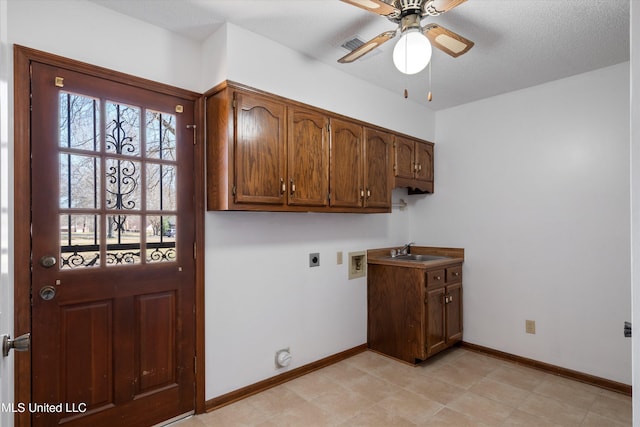 clothes washing area featuring baseboards, washer hookup, cabinet space, hookup for an electric dryer, and a sink