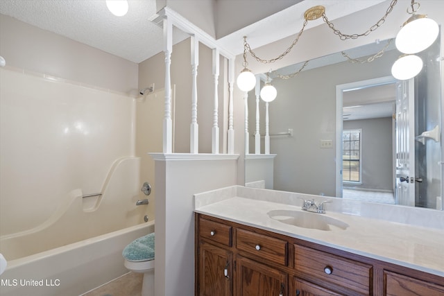 full bath featuring toilet, vanity, a textured ceiling, and shower / tub combination