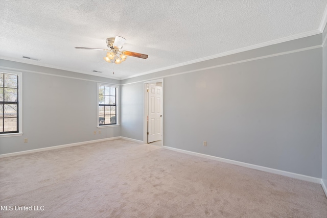 unfurnished room with ornamental molding, baseboards, visible vents, and light carpet