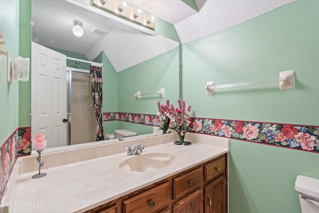 full bath with visible vents, toilet, a stall shower, a textured ceiling, and vanity