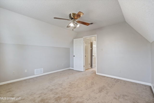 bonus room with a ceiling fan, baseboards, visible vents, carpet floors, and a textured ceiling