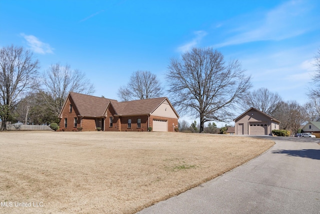 view of front of property with a detached garage and brick siding