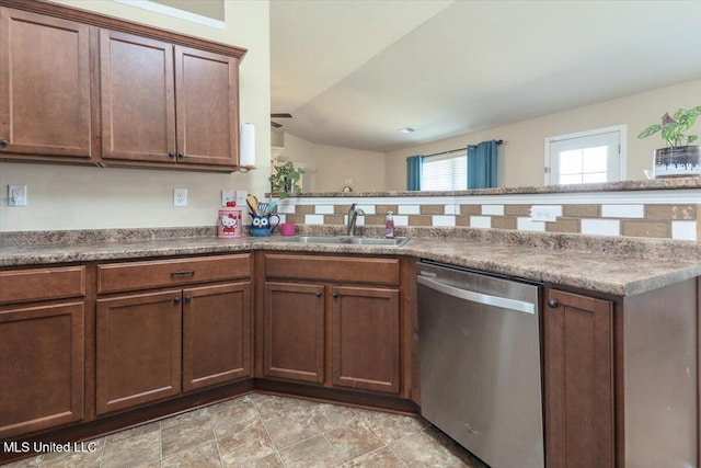 kitchen featuring dishwasher, a sink, and a peninsula