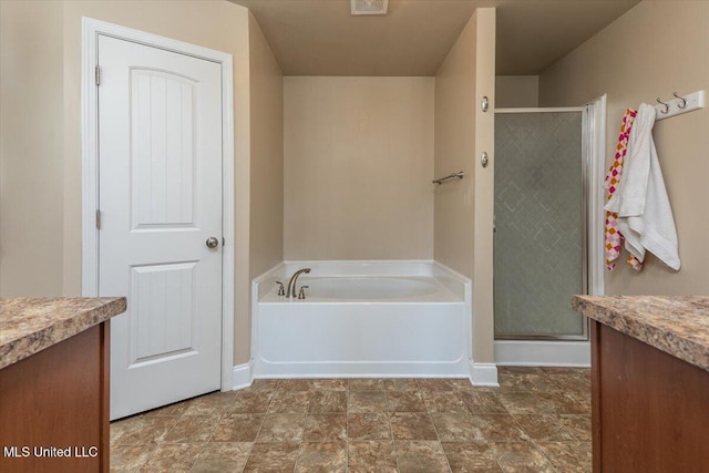 bathroom featuring a bath, baseboards, vanity, and a shower stall