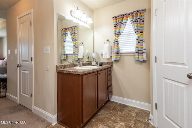 bathroom featuring vanity and baseboards