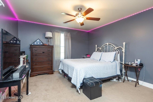 bedroom featuring baseboards, carpet floors, visible vents, and a ceiling fan