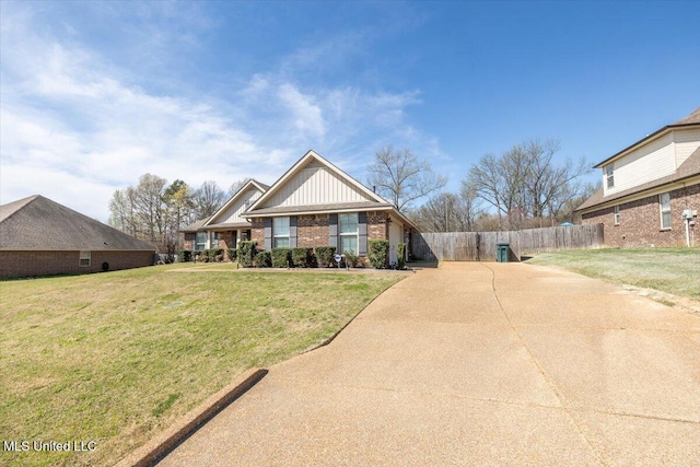 view of front of home featuring driveway, fence, board and batten siding, brick siding, and a front lawn