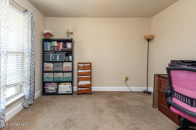 carpeted office featuring baseboards