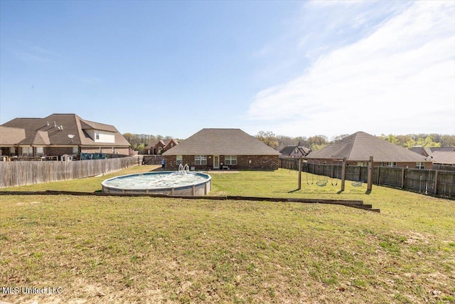 view of yard with a fenced backyard and a fenced in pool