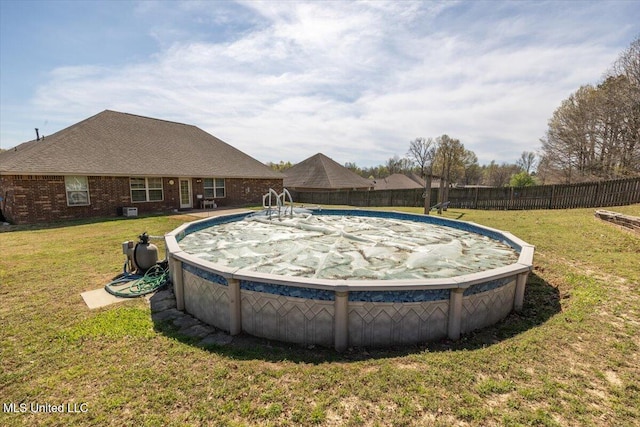 view of pool with a fenced backyard, a fenced in pool, and a lawn