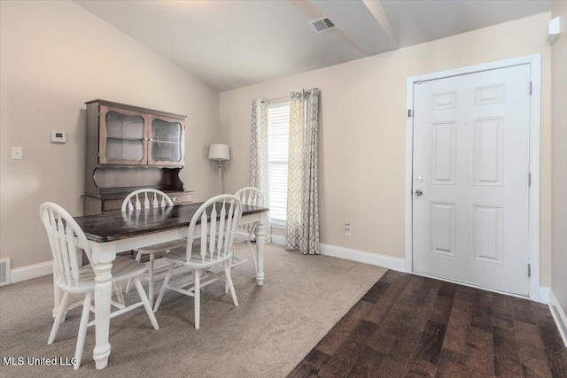 dining room featuring baseboards, lofted ceiling, and visible vents