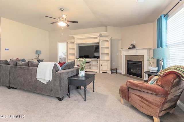 living room featuring a fireplace, lofted ceiling, ceiling fan, and carpet flooring