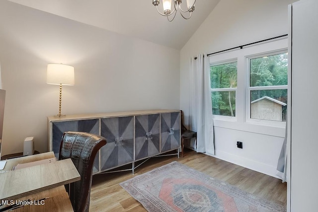 bedroom with an inviting chandelier, wood finished floors, and high vaulted ceiling