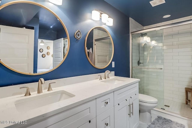 full bath with a sink, a shower stall, and visible vents