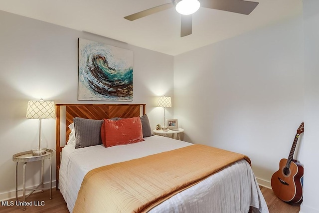 bedroom with baseboards, ceiling fan, and wood finished floors