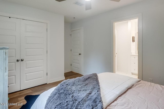 bedroom with ceiling fan, visible vents, wood finished floors, a closet, and ensuite bathroom