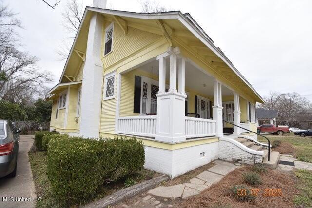 view of property exterior featuring a porch