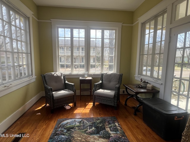 sitting room featuring plenty of natural light, baseboards, and wood finished floors