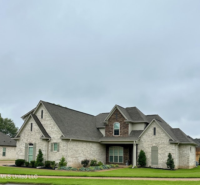 4049 Courtyard Dr, Southaven, MS 38671 - french country style house with roof with shingles, a front lawn, and brick siding