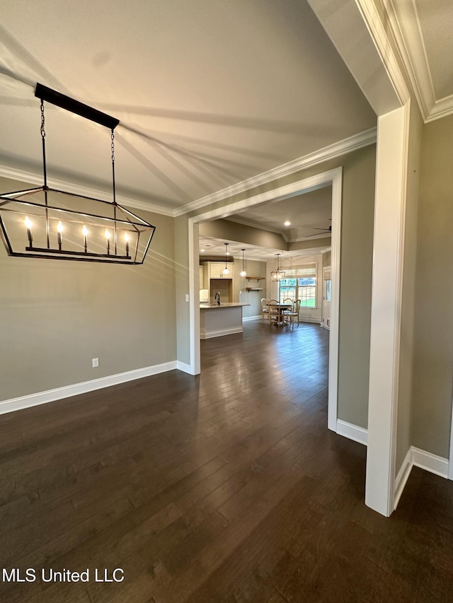 4049 Courtyard Dr, Southaven, MS 38671 - unfurnished living room featuring ornamental molding, a chandelier, baseboards, and dark wood-type flooring