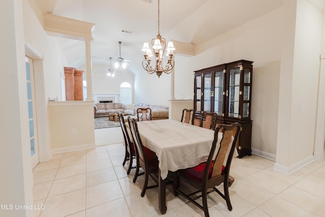 104 Overbrook Hl, Ridgeland, MS 39157 - dining room with vaulted ceiling, light tile patterned floors, ceiling fan, a fireplace, and a chandelier