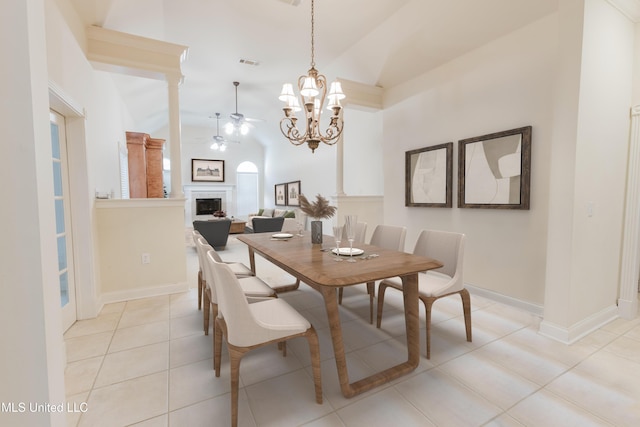 104 Overbrook Hl, Ridgeland, MS 39157 - dining space with a fireplace, ceiling fan, light tile patterned floors, high vaulted ceiling, and a chandelier