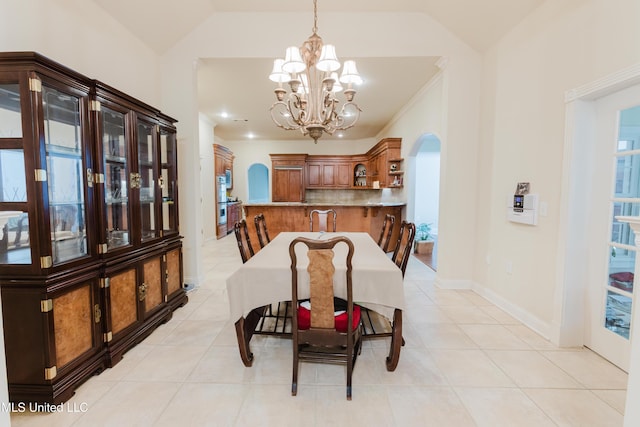 104 Overbrook Hl, Ridgeland, MS 39157 - dining area featuring arched walkways, a chandelier, light tile patterned floors, and lofted ceiling