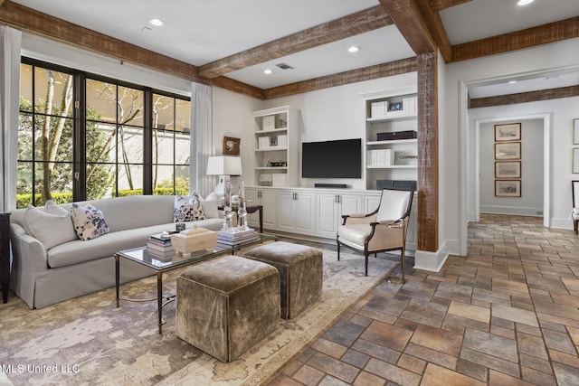 living room with baseboards, stone tile flooring, built in shelves, beam ceiling, and recessed lighting