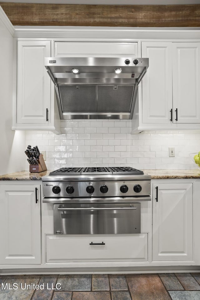 kitchen featuring tasteful backsplash, white cabinetry, and exhaust hood