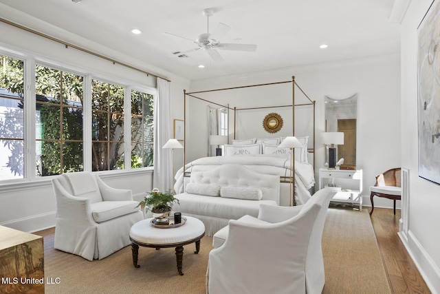 bedroom featuring baseboards, ornamental molding, wood finished floors, and recessed lighting