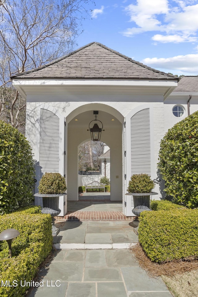 view of exterior entry with a porch and cooling unit