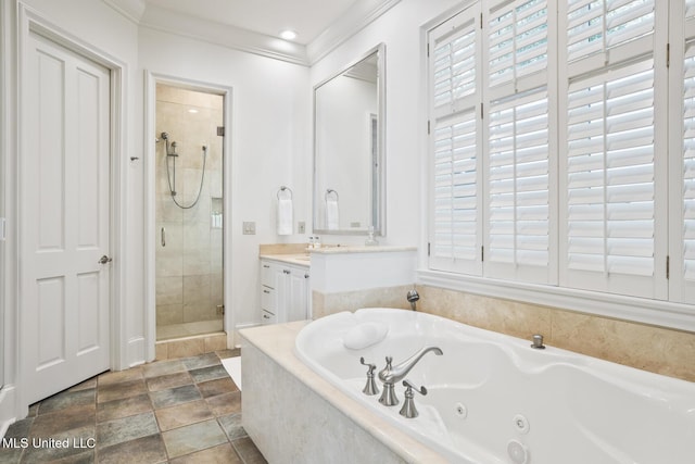 bathroom featuring a whirlpool tub, a stall shower, ornamental molding, and vanity