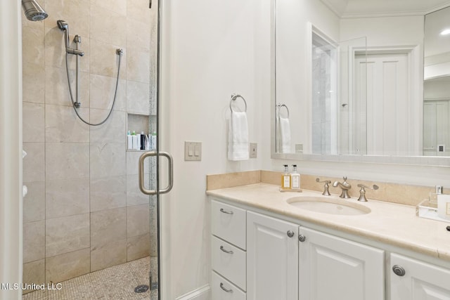 bathroom with a shower stall and vanity