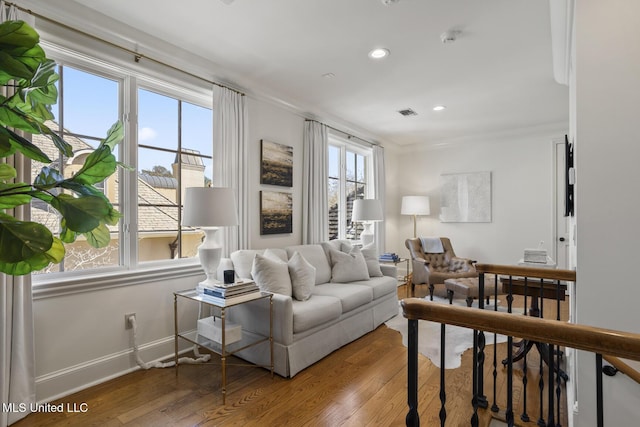 living room with recessed lighting, wood finished floors, visible vents, and baseboards