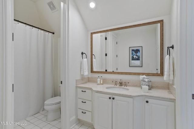 bathroom featuring visible vents, vanity, toilet, and tile patterned floors