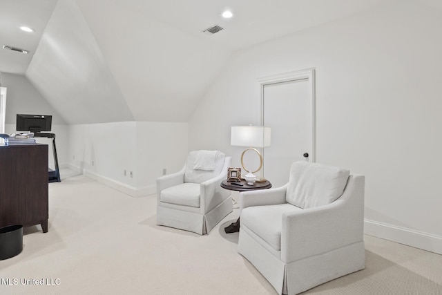 sitting room with vaulted ceiling, carpet flooring, visible vents, and baseboards