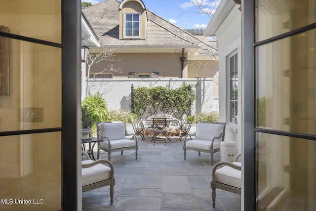 balcony with outdoor dining area and a patio area