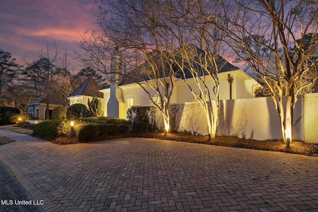 view of front of home featuring fence and stucco siding