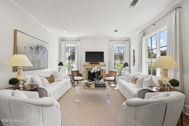 living area with a fireplace, visible vents, crown molding, and recessed lighting