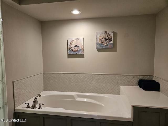 bathroom with a tub to relax in