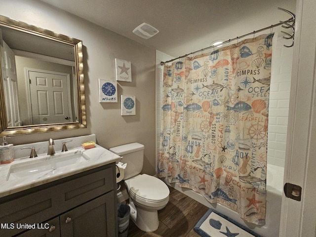 full bathroom featuring shower / tub combo, vanity, toilet, and hardwood / wood-style floors