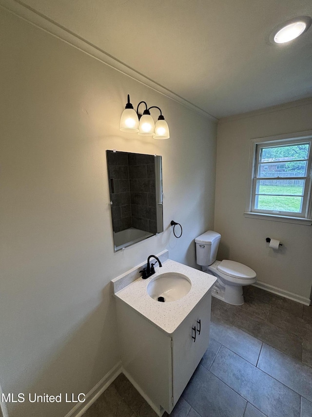 full bath with vanity, baseboards, crown molding, and toilet