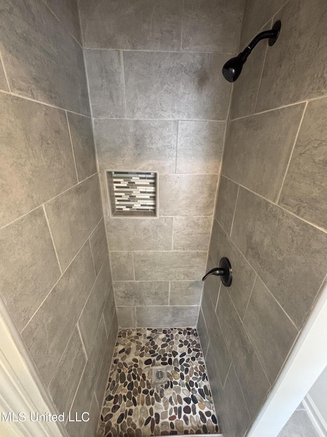bathroom with tiled shower