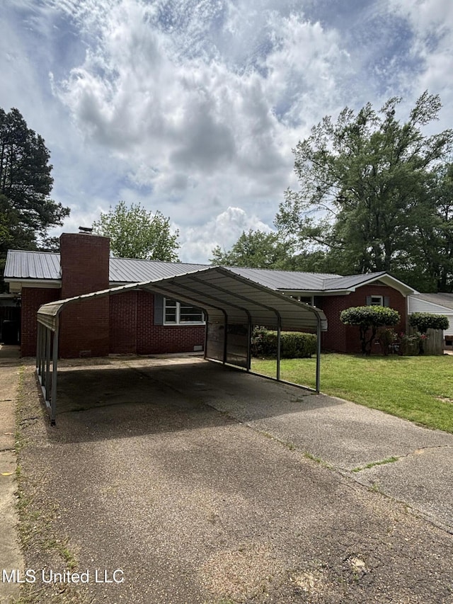 view of car parking featuring a detached carport and driveway