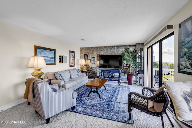 1130 Beach Blvd Unit 503, Biloxi, MS 39530 - living room featuring carpet, baseboards, and a textured ceiling