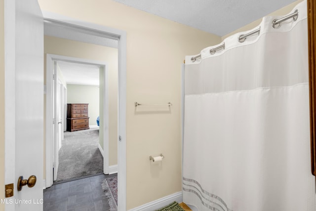1130 Beach Blvd Unit 503, Biloxi, MS 39530 - bathroom featuring baseboards and curtained shower